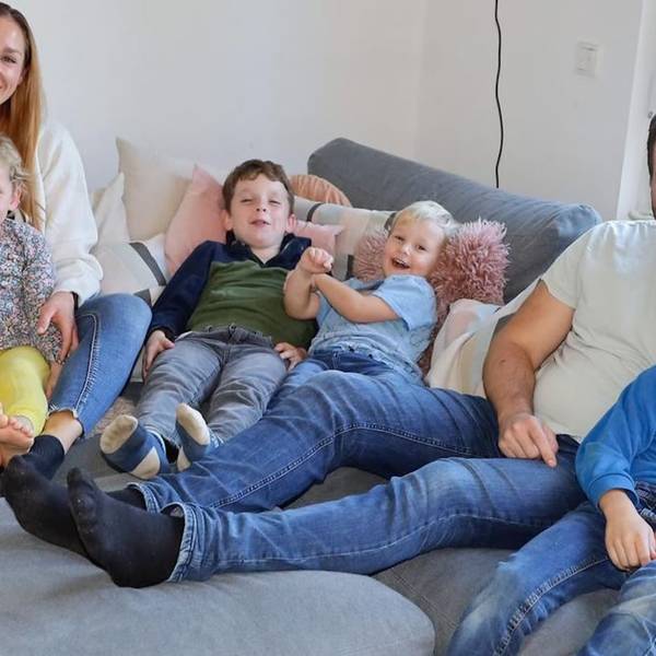 Porträt einer Großfamilie: Eltern und fünf Kinder auf einem Sofa