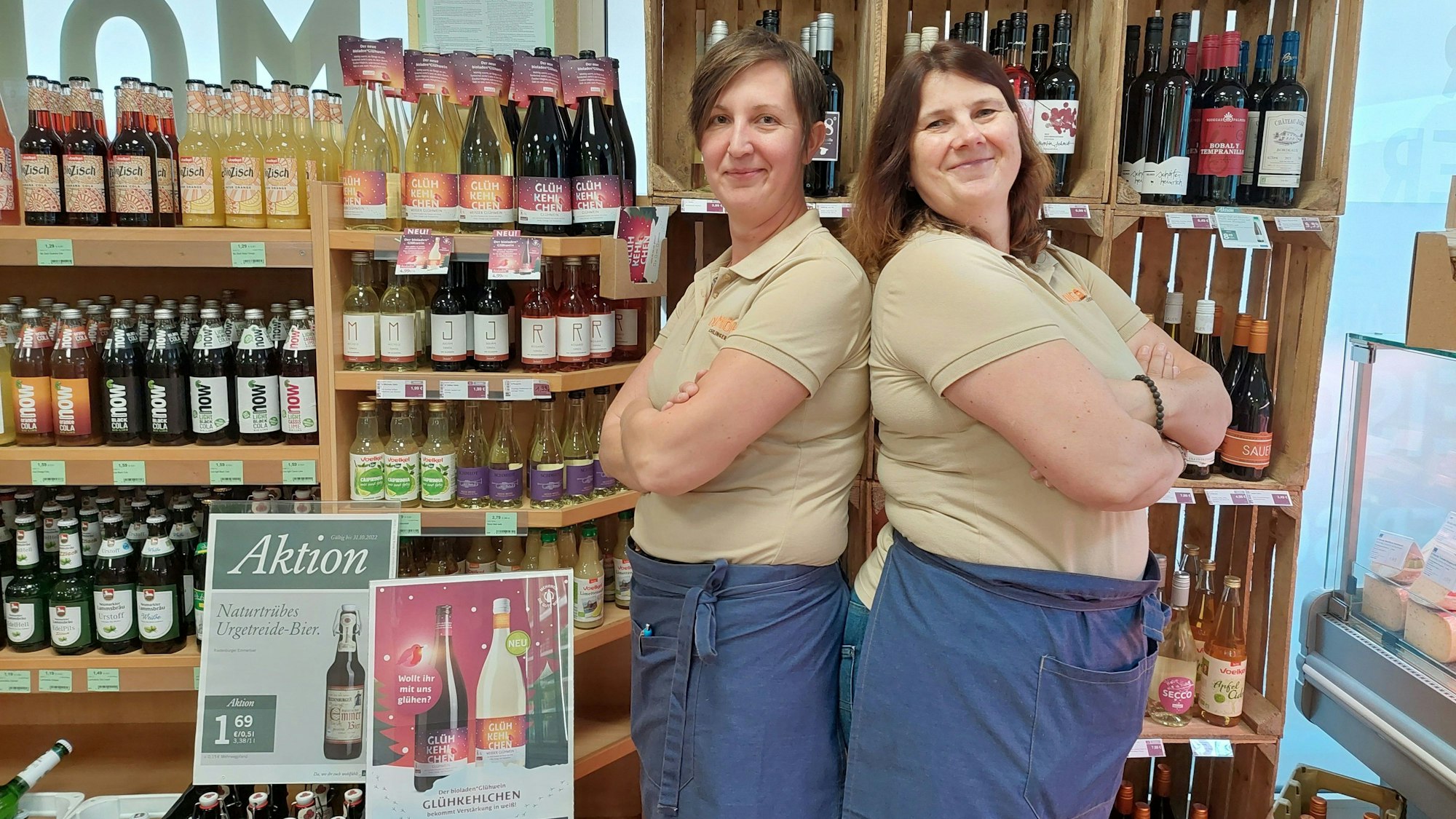 Saskia und Ulrike Effey stehen vor einem Regal voller Bio-Weine und Säfte.