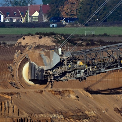 Nordrhein-Westfalen, Jüchen: Ein Schaufelradbagger arbeitet im Braunkohletagebau Garzweiler. Im Hintergrund ist die Ortschaft Lützerath zu sehen.