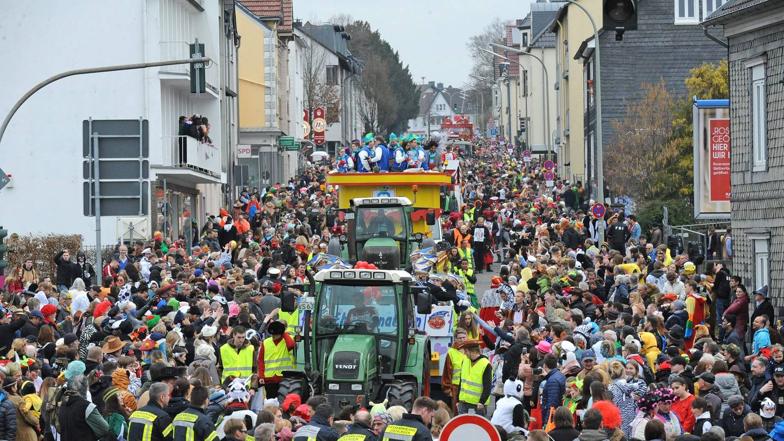 Der Karnevalszug zieht mit Traktoren und Festwagen 2021 die dicht bevölkerte Bahnhofstraße hinunter.