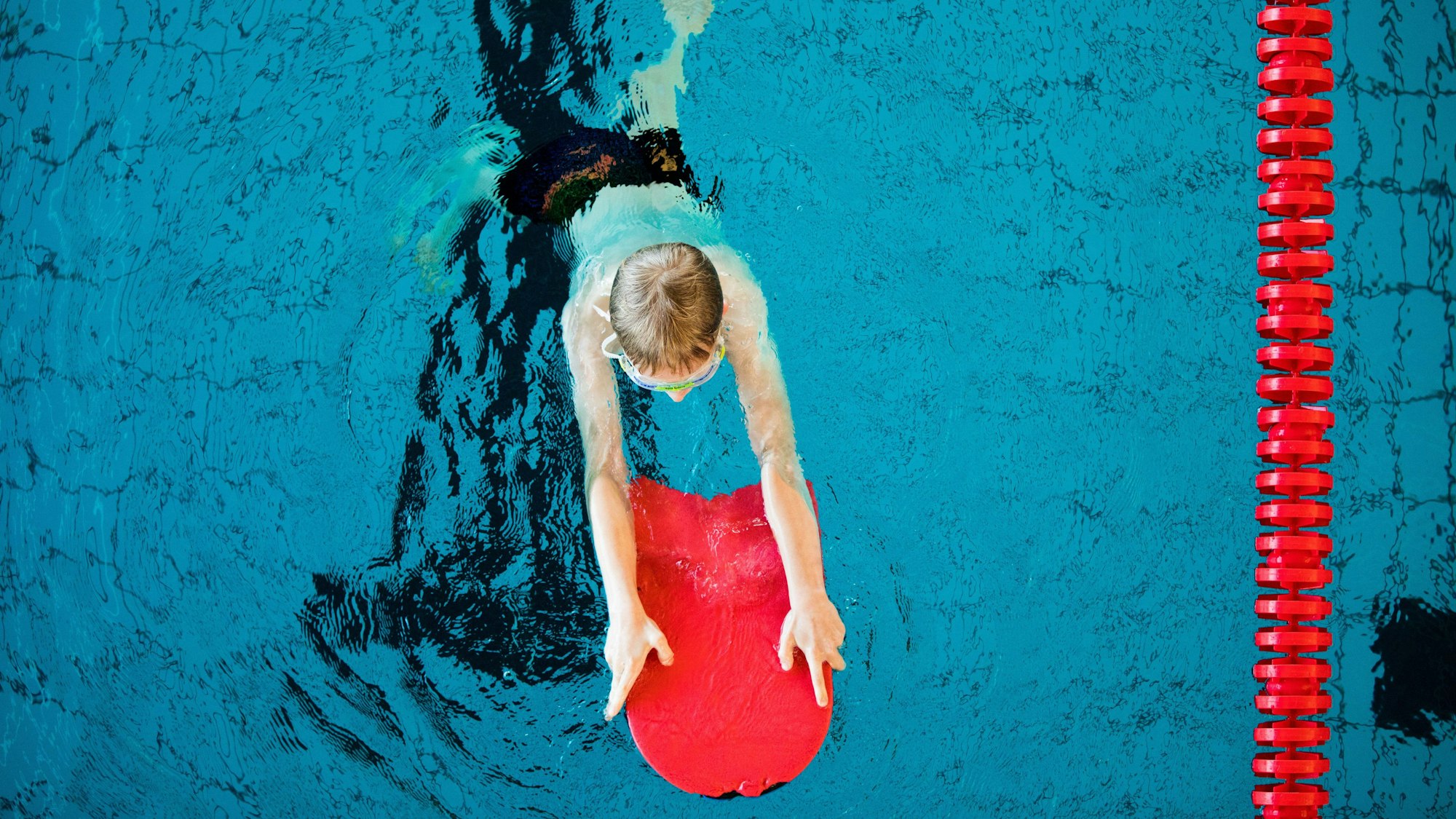 Ein Junge nimmt an einem Schwimmkurs für Kinder teil.