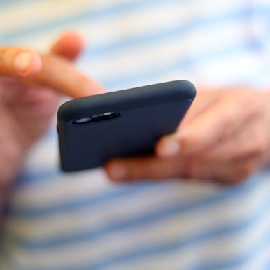 Eine Frau tippt auf einem Smartphone.