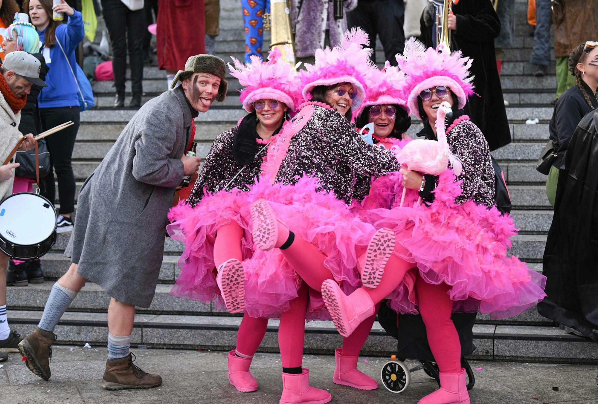 Vier Frauen haben sich als Flamingos verkleidet und posieren in der Altstadt.