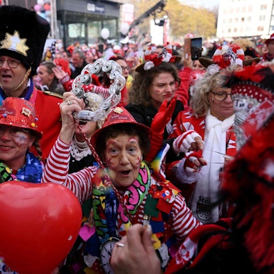 Mehrere Jecken feiern Karneval. Sie sind verkleidet und geschminkt.