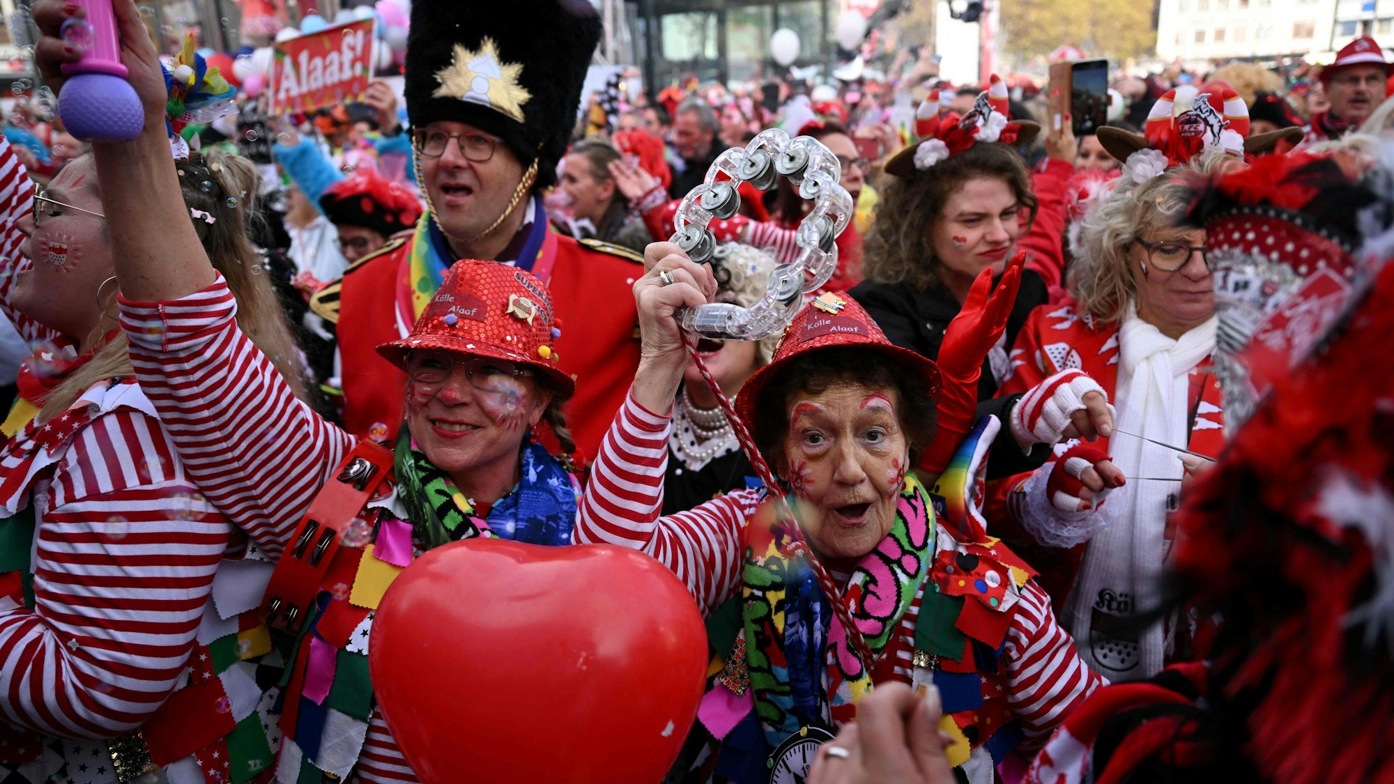 Mehrere Jecken feiern Karneval. Sie sind verkleidet und geschminkt.