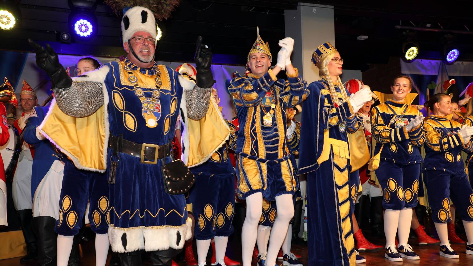 Overaths neues Dreigestirn tanzt bei der Proklamation auf der Bühne der Cyriax-Aula.