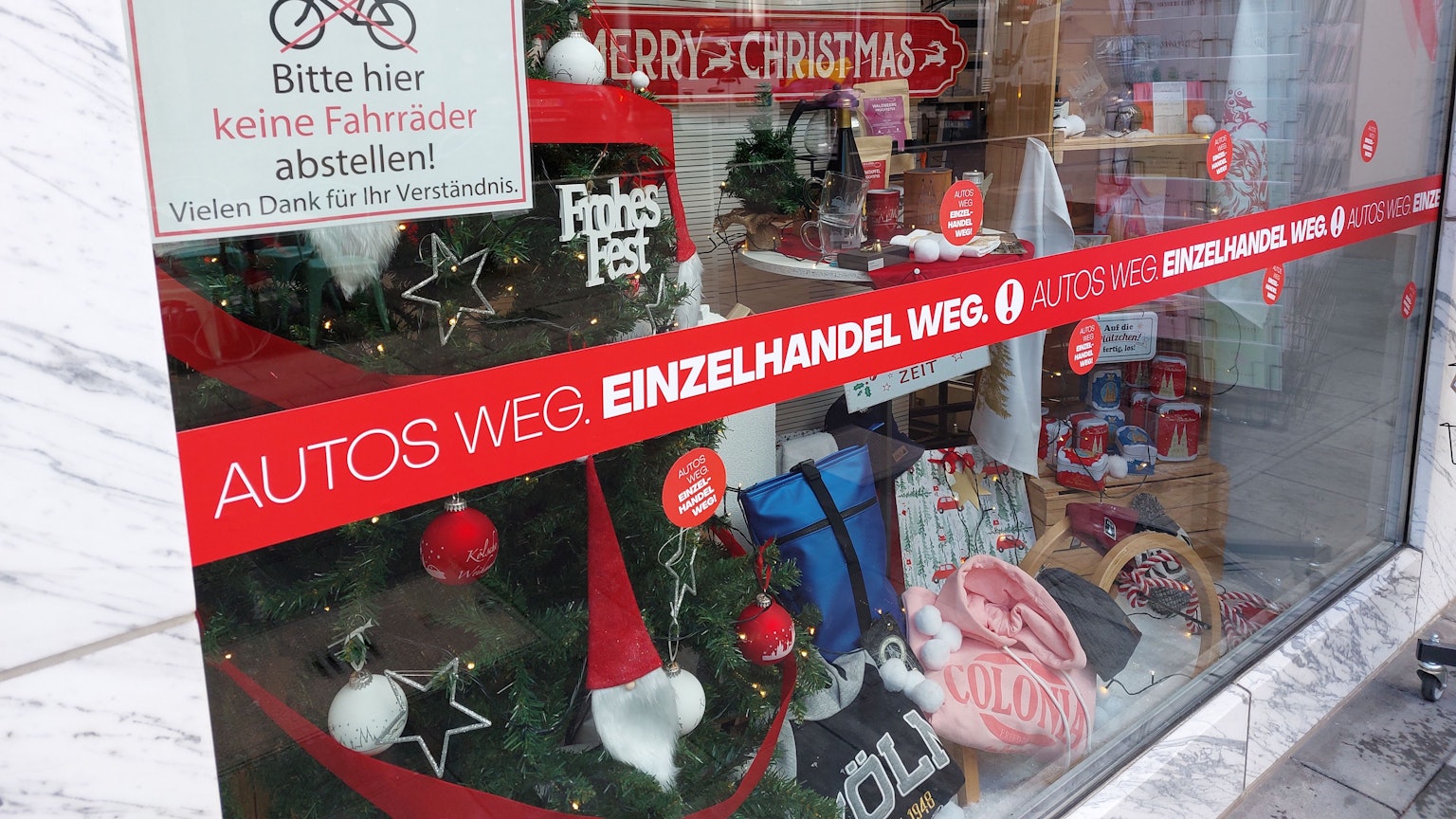 An einem Schaufenster auf der Deutzer Freiheit liest man „Autos weg, Einzelhandel weg“.