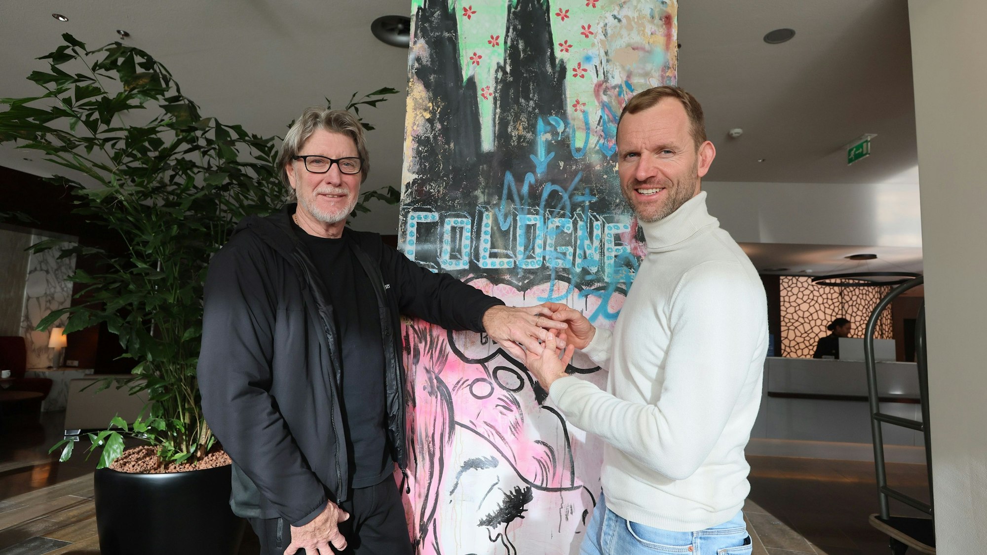 Der Arzt Markus Klingenberg untersucht die Hand von Toni Schumacher.