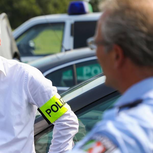 Dirk Weinspach ist bei einem Einsatz zu sehen. Er trägt ein weißes Hemd und eine neongelbe Polizei-Binde am Arm.