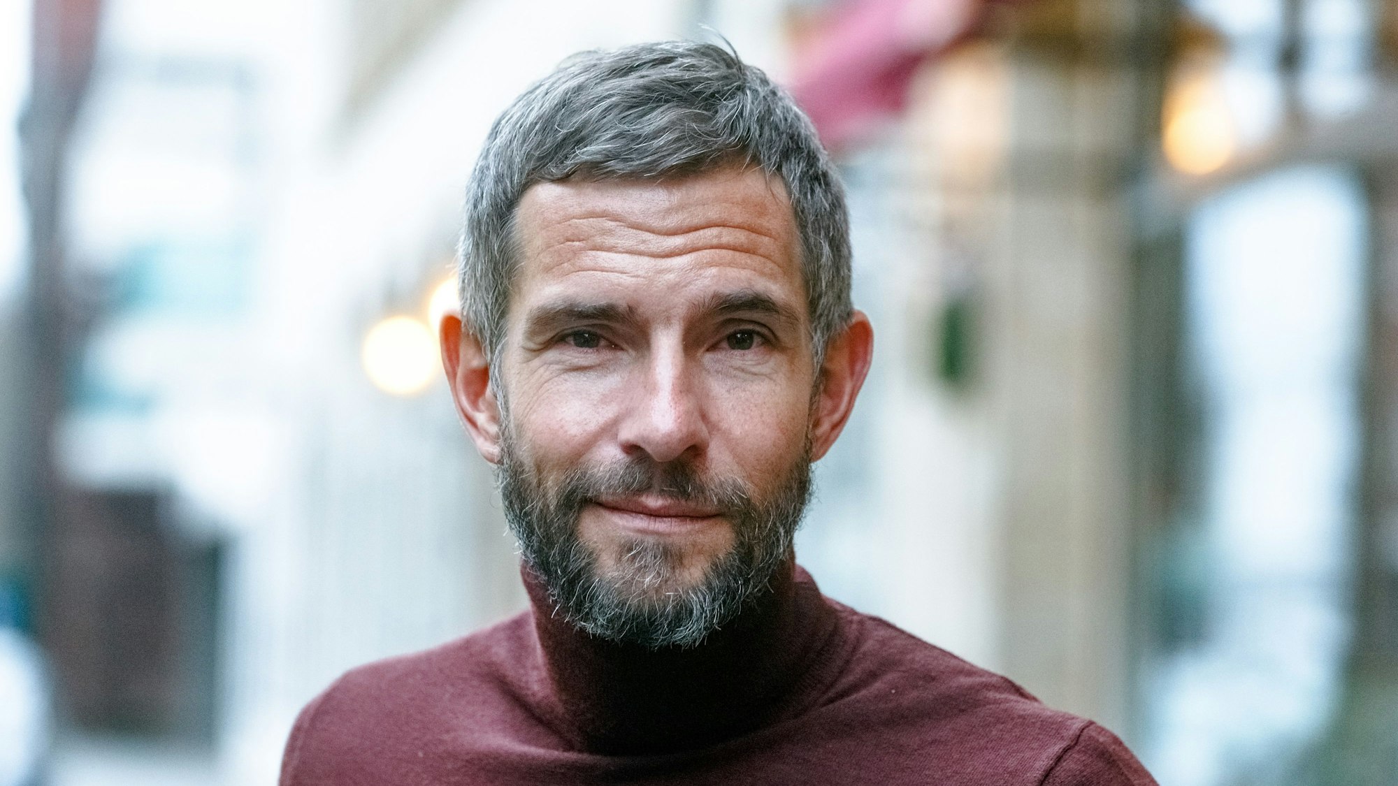 Der Journalist und Autor Micky Beisenherz steht in seinem Wohnviertel auf der Straße.