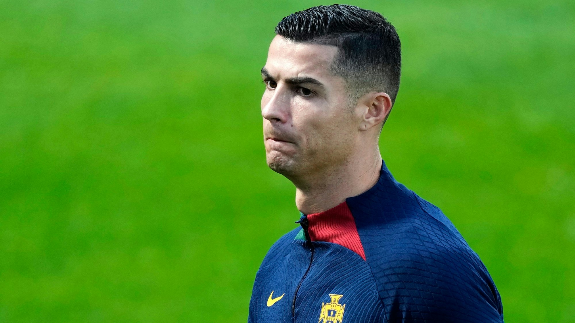 Fußballstar Christiono Ronaldo steht auf einem Fußballfeld.