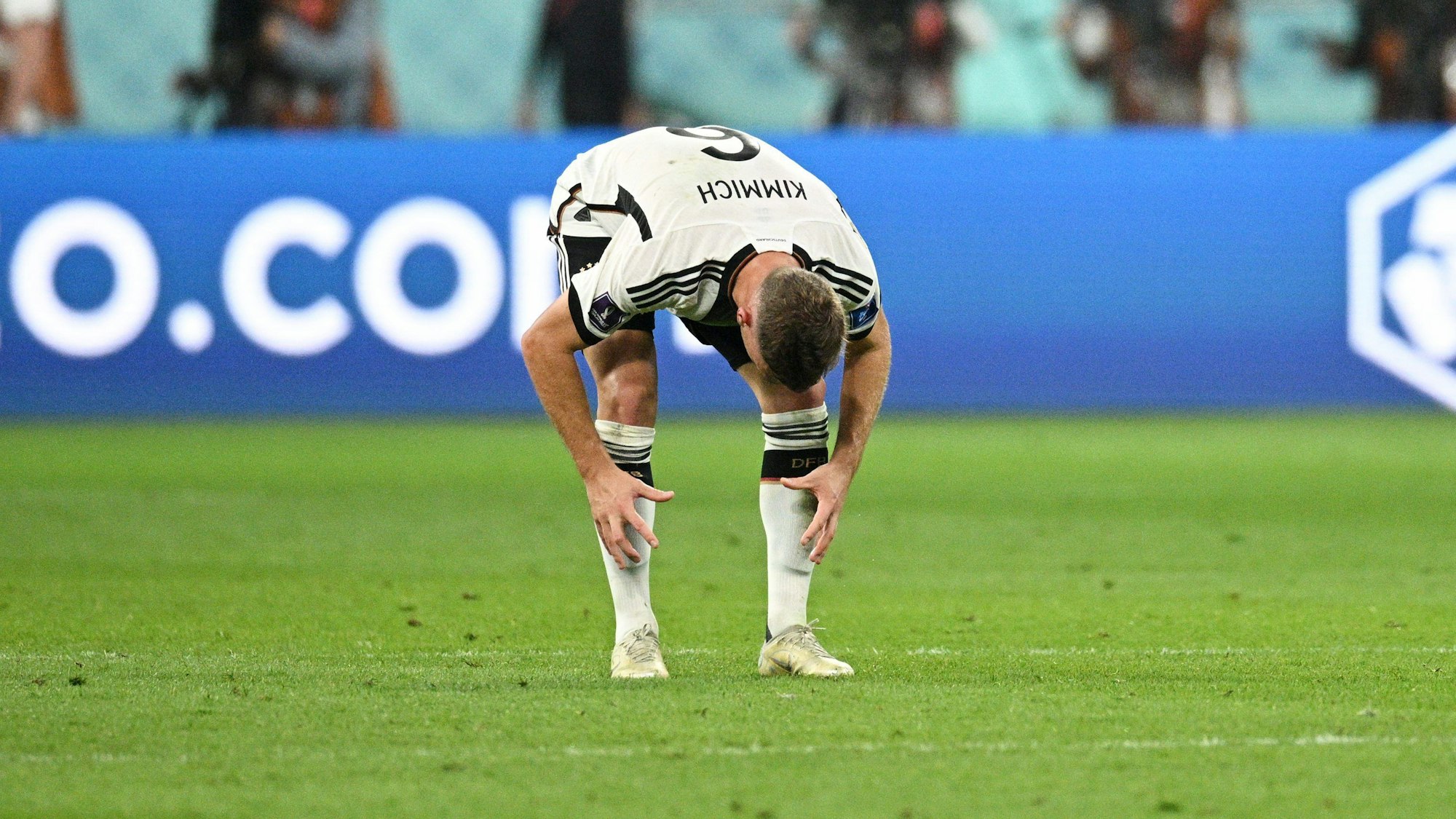 Deutschlands Nationalspieler Joshua Kimmich beugt sich auf dem Spielfeld frustriert nach vorne.