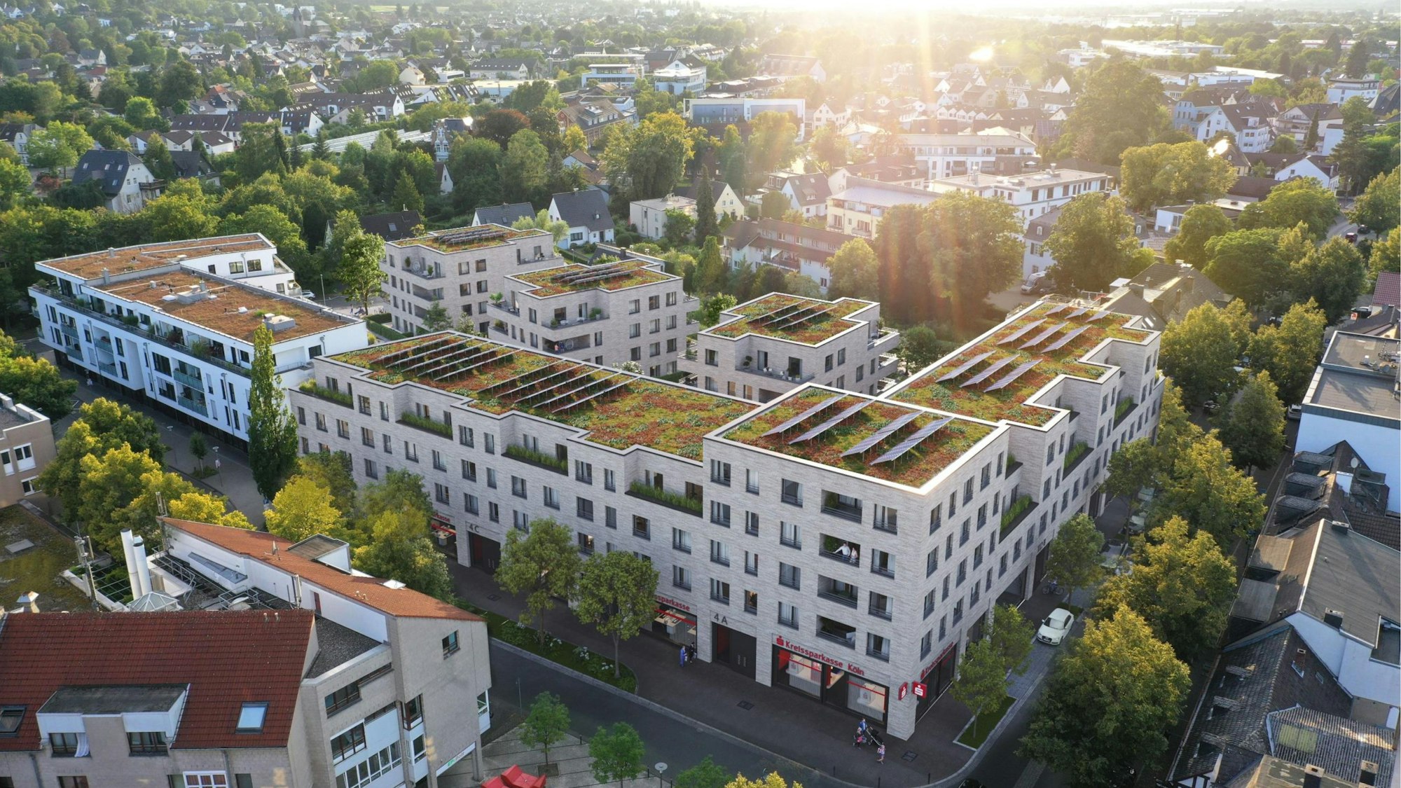 Die Visualisierung zeigt einen neuen Gebäudekomplex mit grünen Dächern und Solarpaneelen.