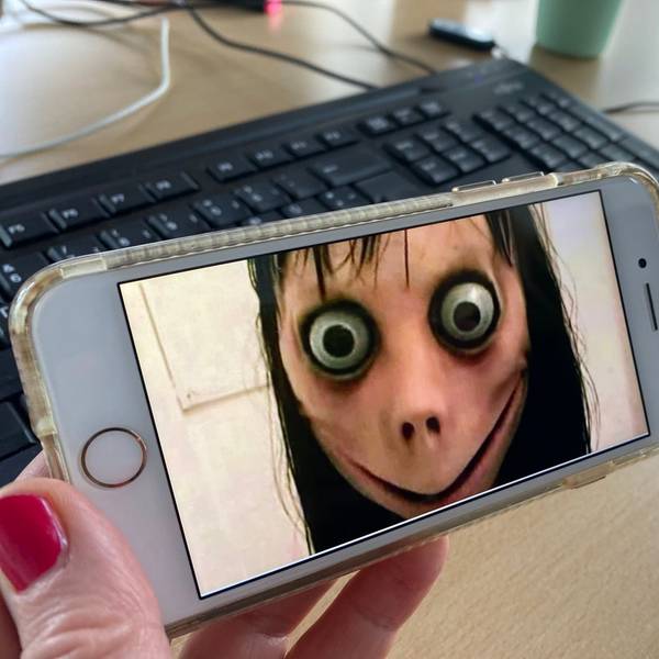 Ein Bild der Gruselfigur Momo ist auf einem Handy zu sehen.