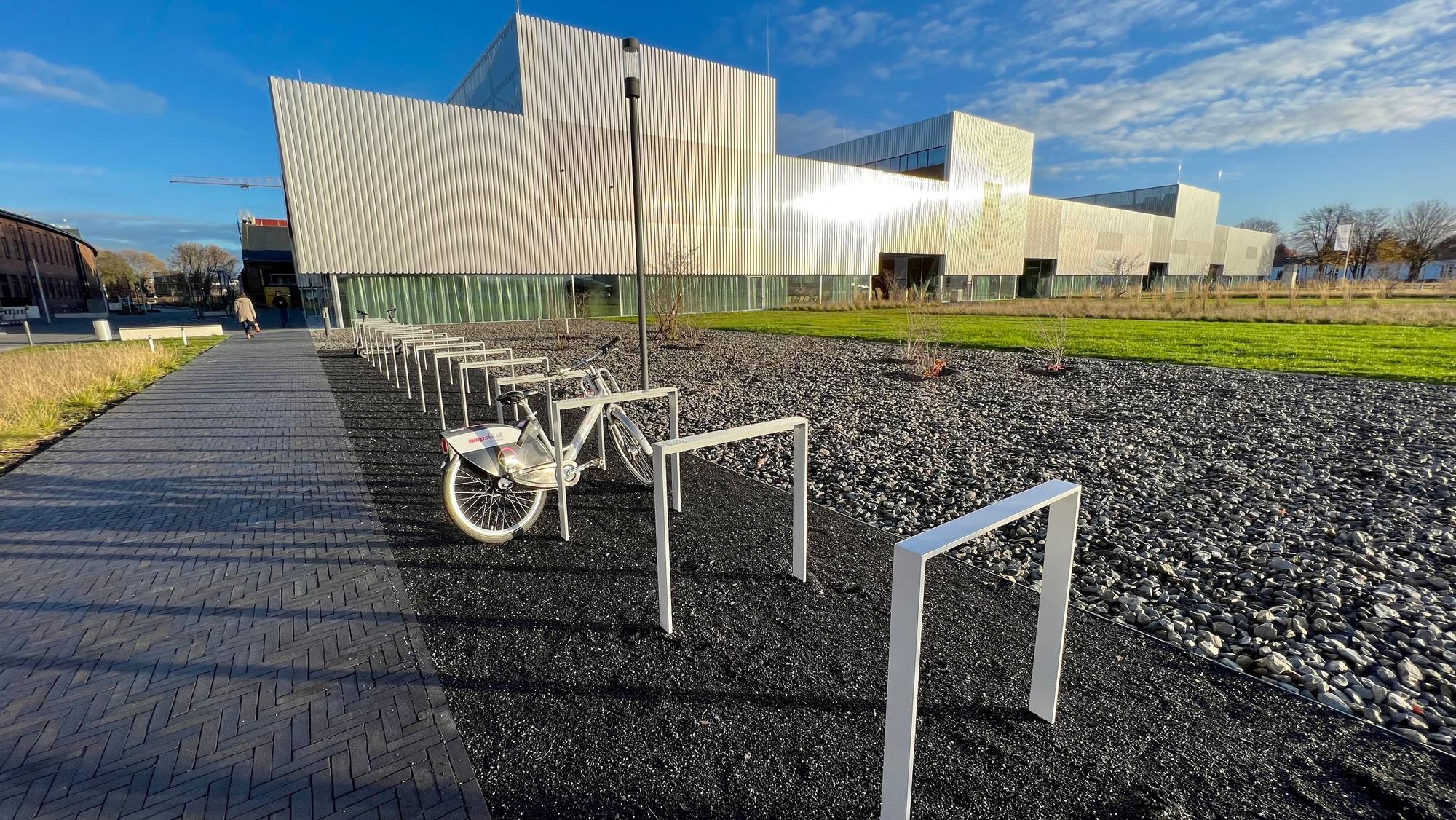 Fahrradständer vor der glitzernden Fassade des Hochschulcampus in Opladen.