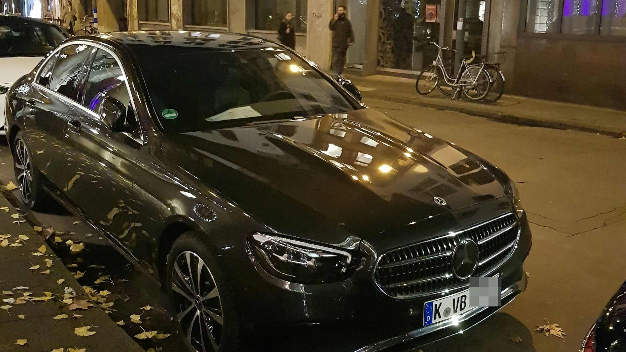 Ein schwarzer Mercedes steht am Straßenrand.