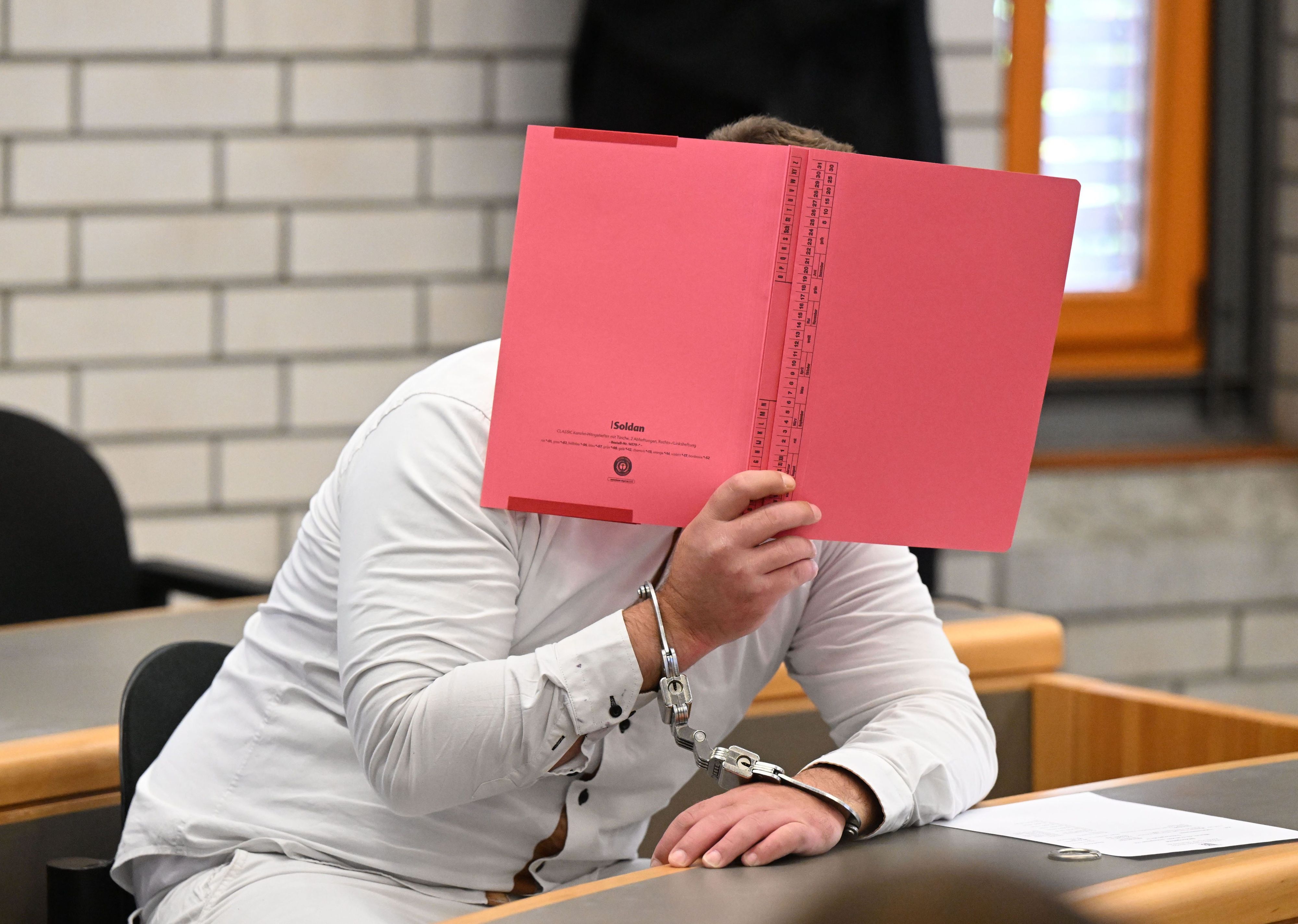 Der Angeklagte im Prozess wegen Mordes an einer Sechsjährigen und Störung der Totenruhe wartet in einem Verhandlungssaal im Landgericht Baden-Baden auf den Prozessbeginn.
