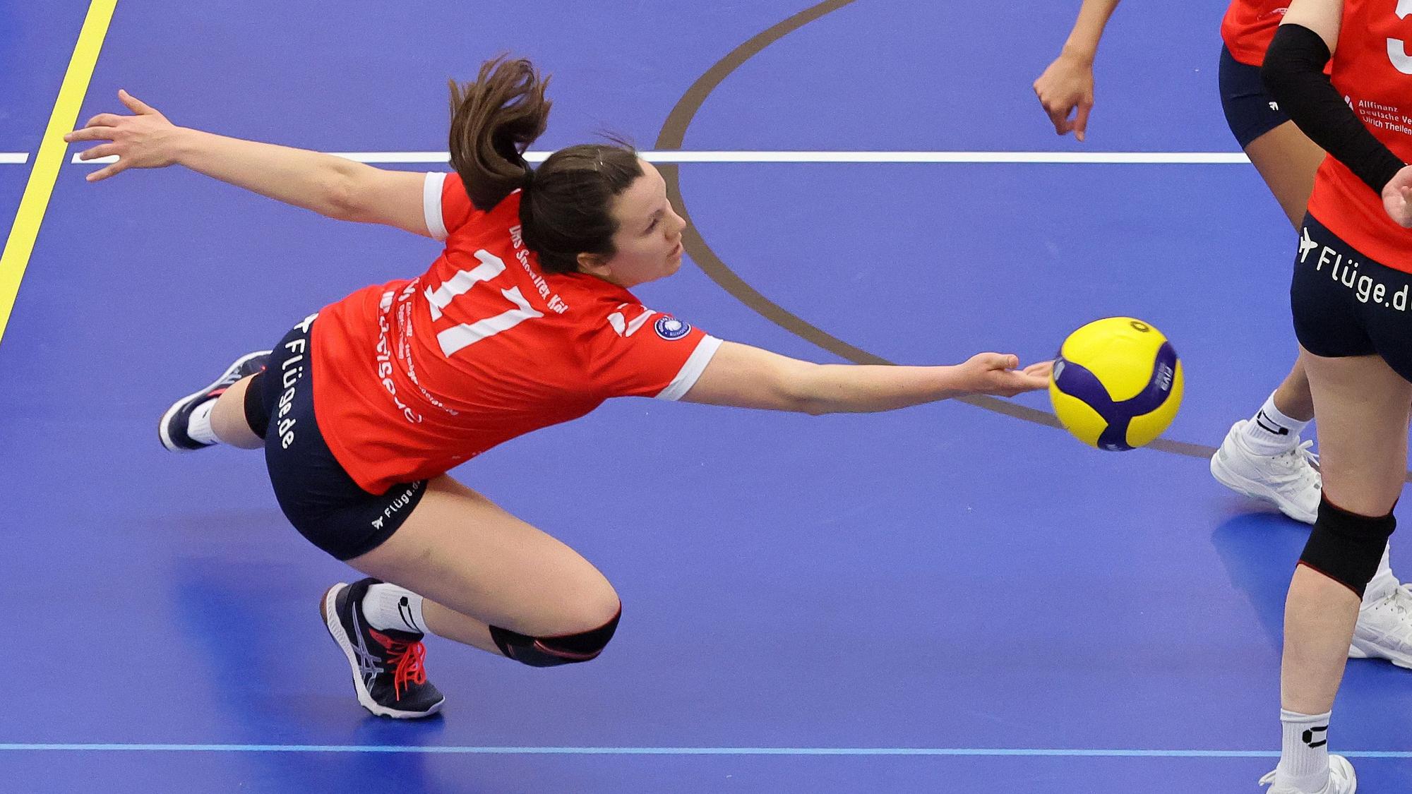 Eine Volleyballspielerin wirft sich dem Ball entgegen.