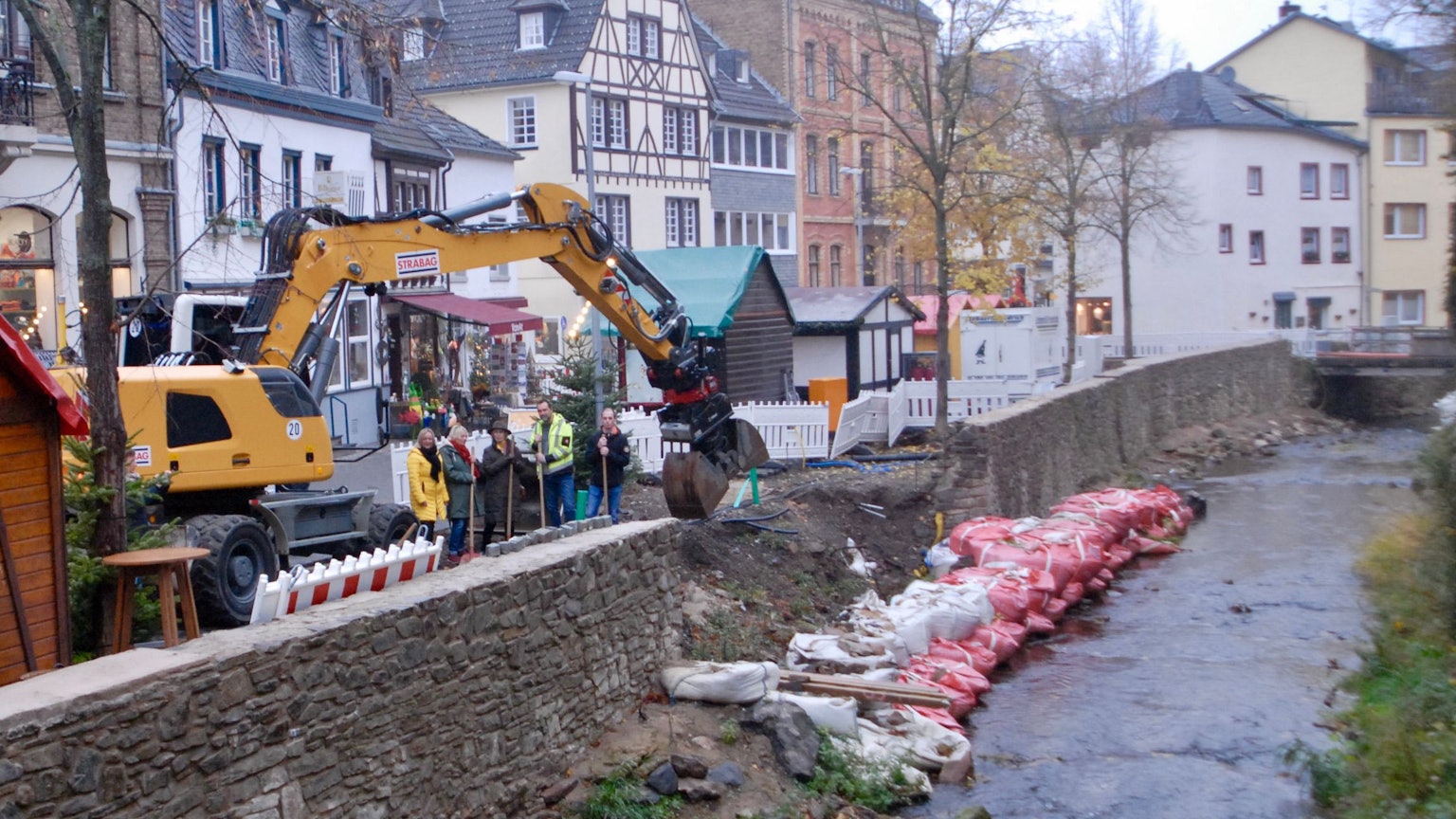 Ein Bagger steht an der Erft in Bad Münstereifel. Dort wird nun eine Freitreppe gebaut.