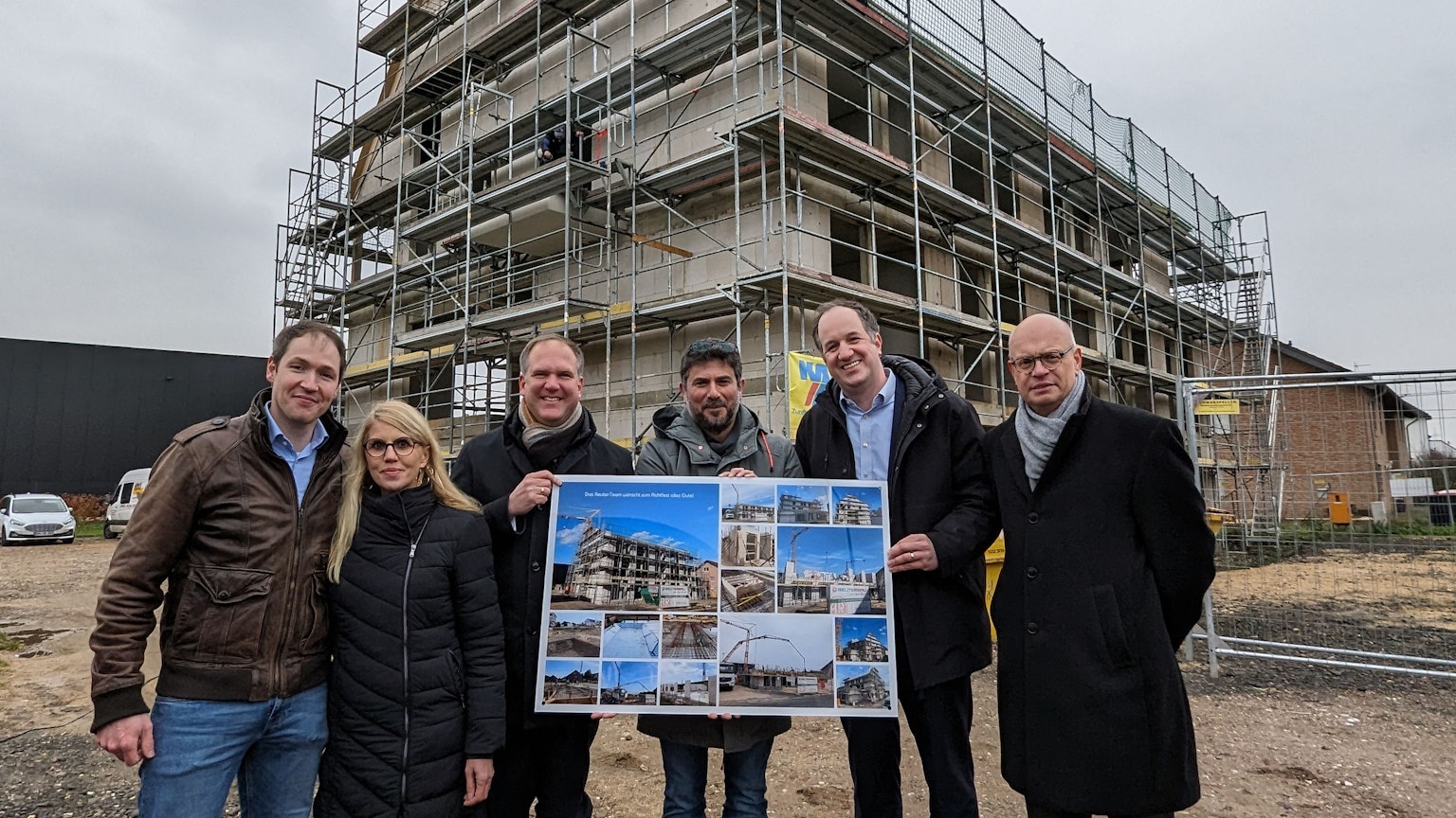 Die Projektverantwortlichen stehen vor dem Neubau des Wohnheims.