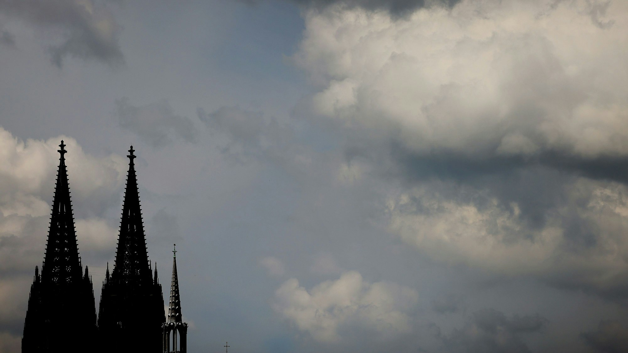 Wolken ziehen am dunklen Dom vorbei. Nur die Domspitzen sind zu sehen.