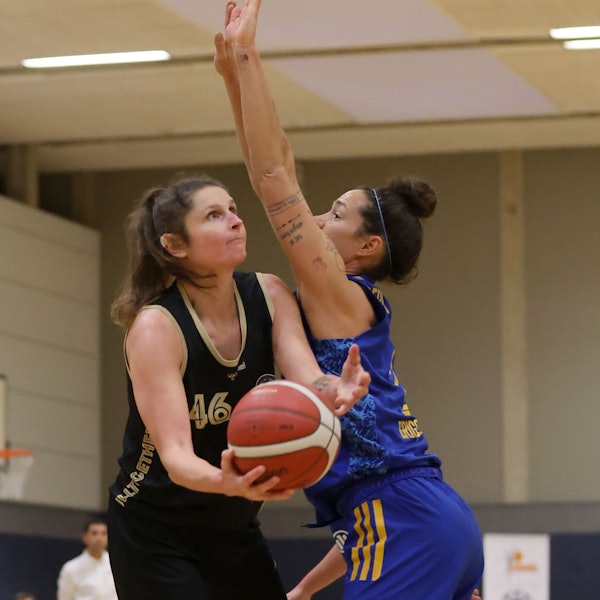 Romy Bär von den Rheinland Lions hält den Basketball in der Hand und versucht gegen ihre Gegnerin von Alba Berlin einen Korb zu erzielen.