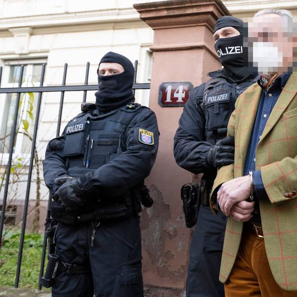 Bei einer Razzia gegen sogenannte „Reichsbürger“ führen vermummte Polizisten, nach der Durchsuchung eines Hauses Heinrich XIII P. R. zu einem Polizeifahrzeug.