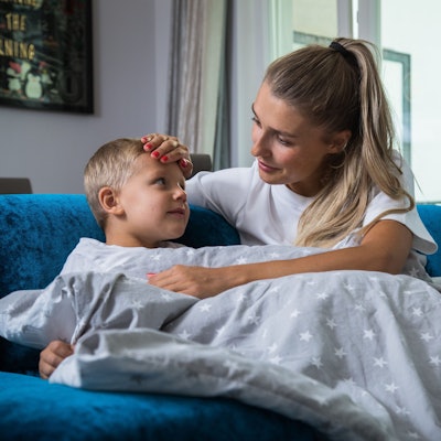 Eine Mutter pflegt ihr krankes Kind.