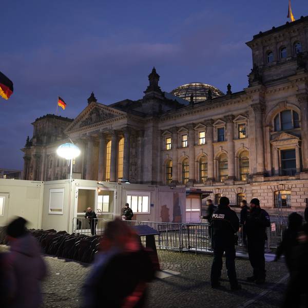 Besucher und Polizisten stehen vor dem Reichstag in Berlin.