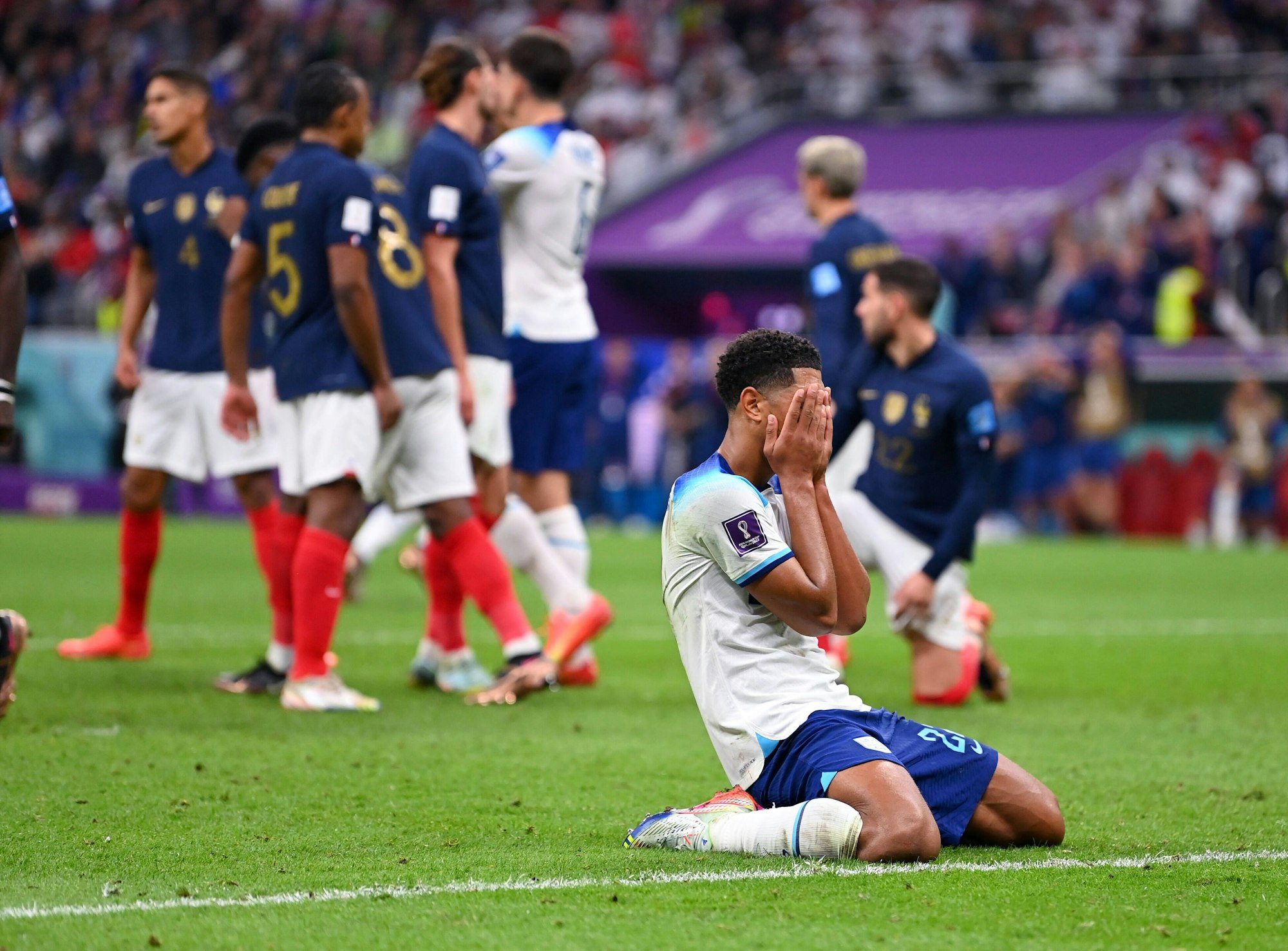 Jude Bellingham, einer von Englands Topspielern, sinkt auf die Knie und verdeckt mit seinen Händen das Gesicht.