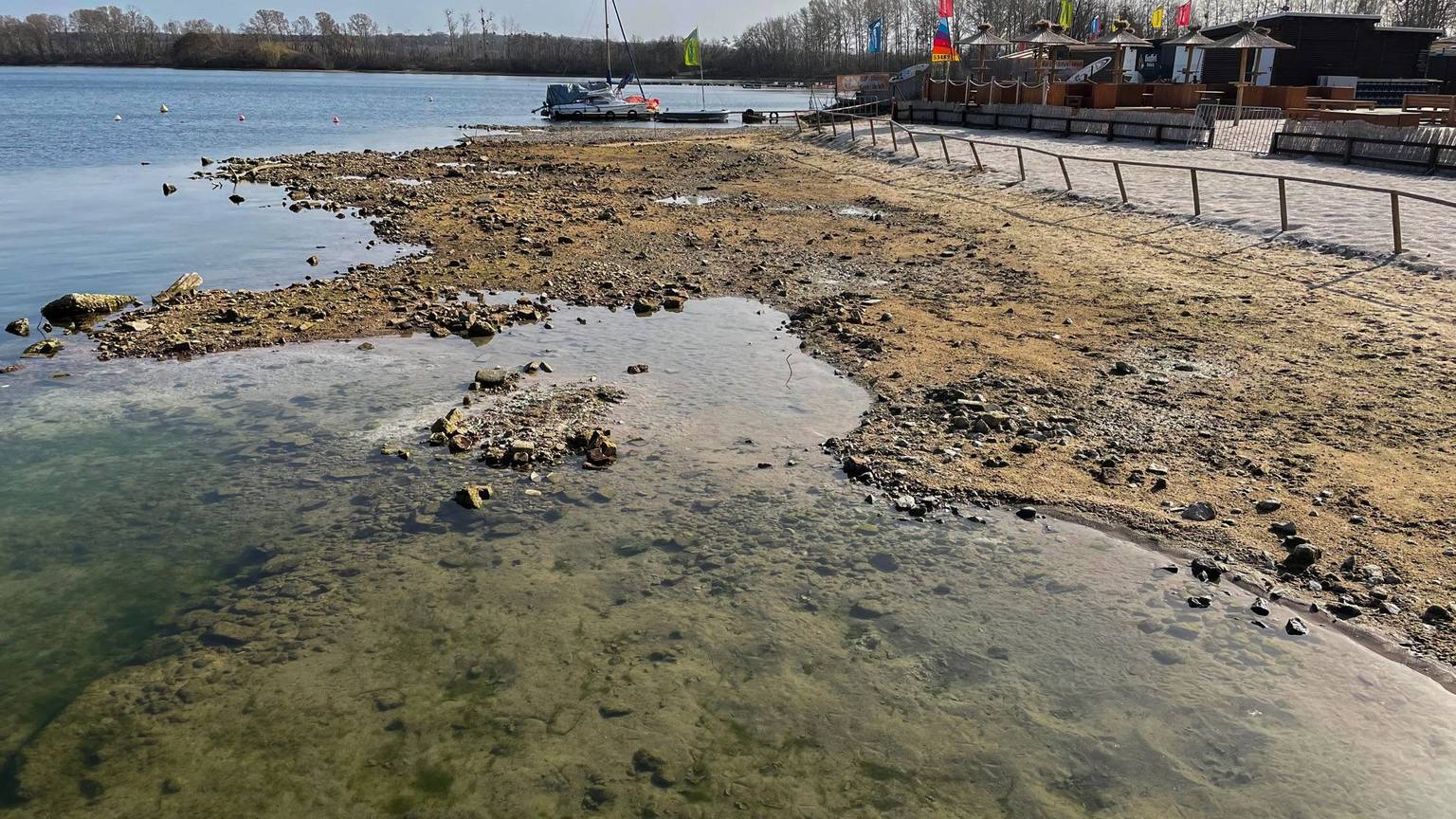 Das Seeufer des Zülpicher Sees. Das Wasser steht einige Meter von der eigentlichen Brüstung entfernt, was zeigt, wie stark der Spiegel des Sees sinkt.