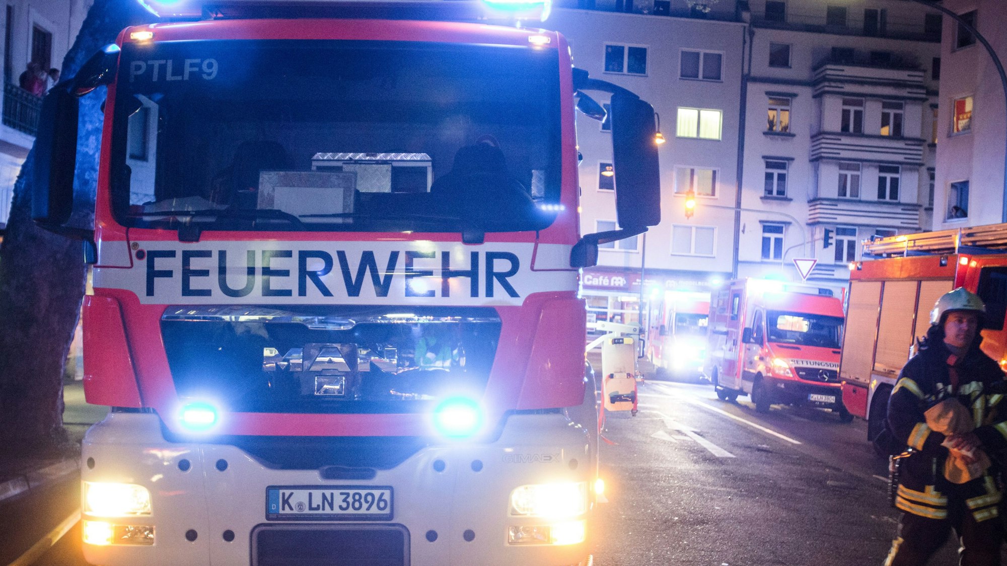 Ein Feuerwehrmann steht neben einem Feuerwehrauto.