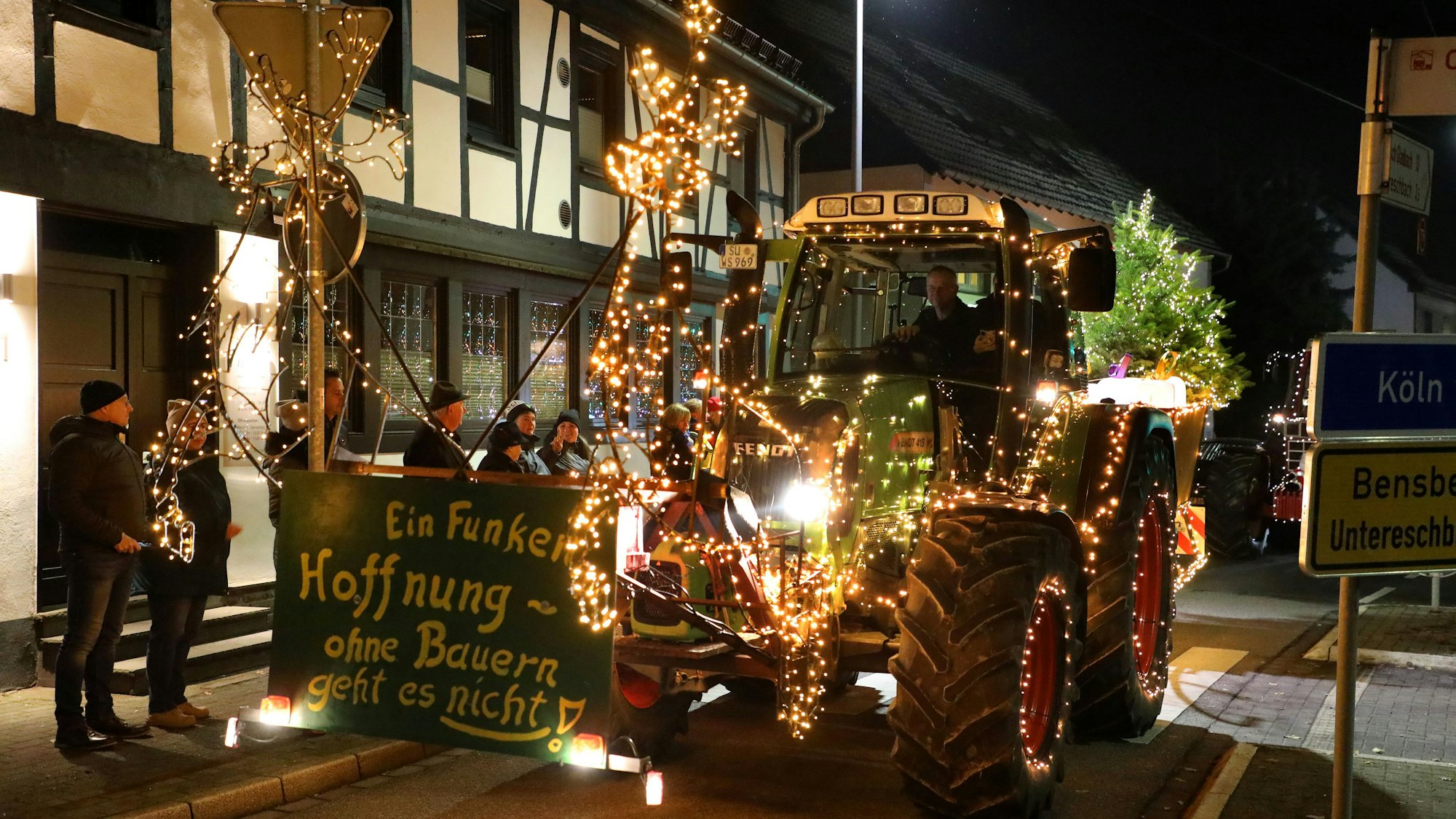 Ein geschmückter Traktor fährt durch die Bensberger Straße in Overath-Heiligenhaus.