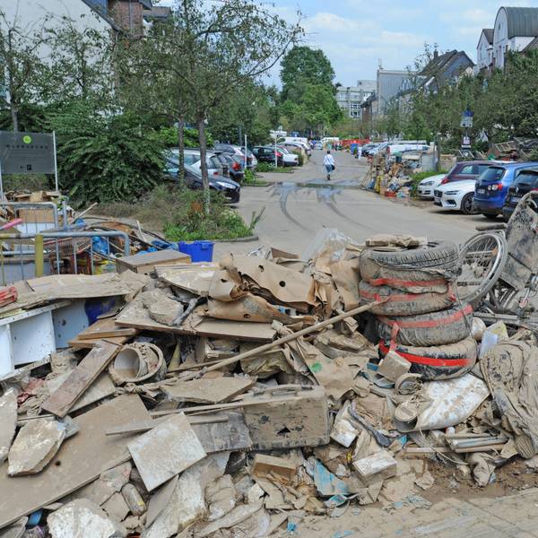 Berge von verschlammten Gegenständen lagern auf der Straße.