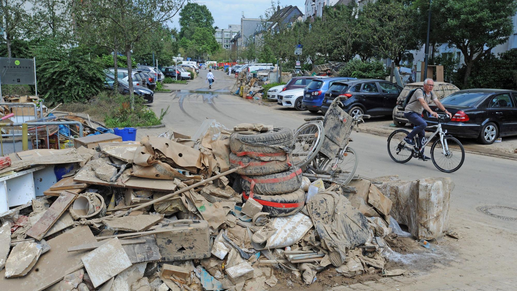 Berge von verschlammten Gegenständen lagern auf der Straße.