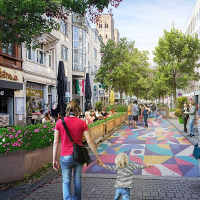 In einer Visualisierung gehen Menschen über die bunt bemalte Deutzer Freiheit.