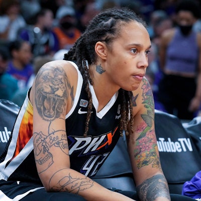 Brittney Griner sitzt während eines Spiels am Rand im Phoenix Mercury Center. Sie schaut ernst.