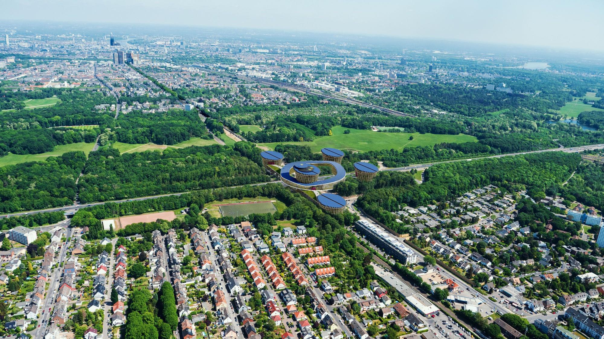 Die Visualisierung zeigt das geplante Mobilitätszentrum über der Autobahn 4 von oben, im Hintergrund ist Köln zu sehen.