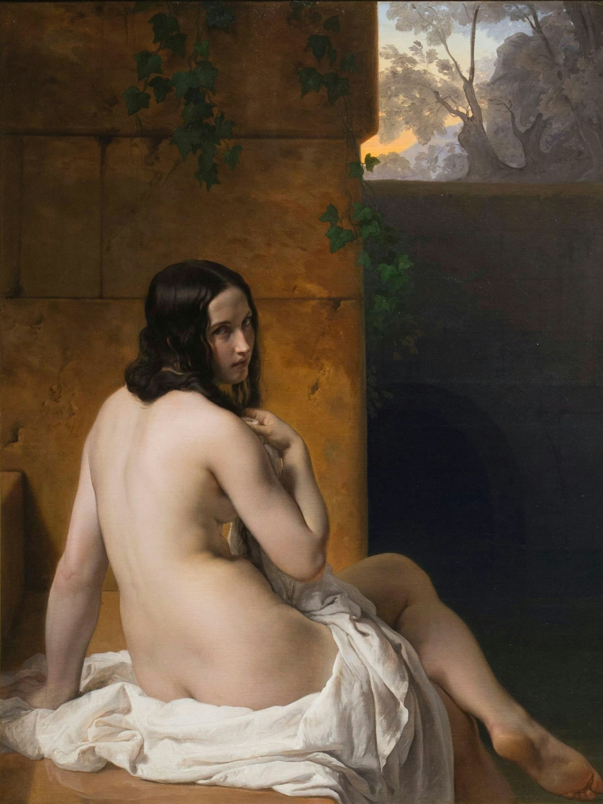 Francesco Hayez' Gemälde Susanna im Bade zeigt eine nackte Frau in Rückenansicht, während sie den Betrachter über die Schulter anblickt.