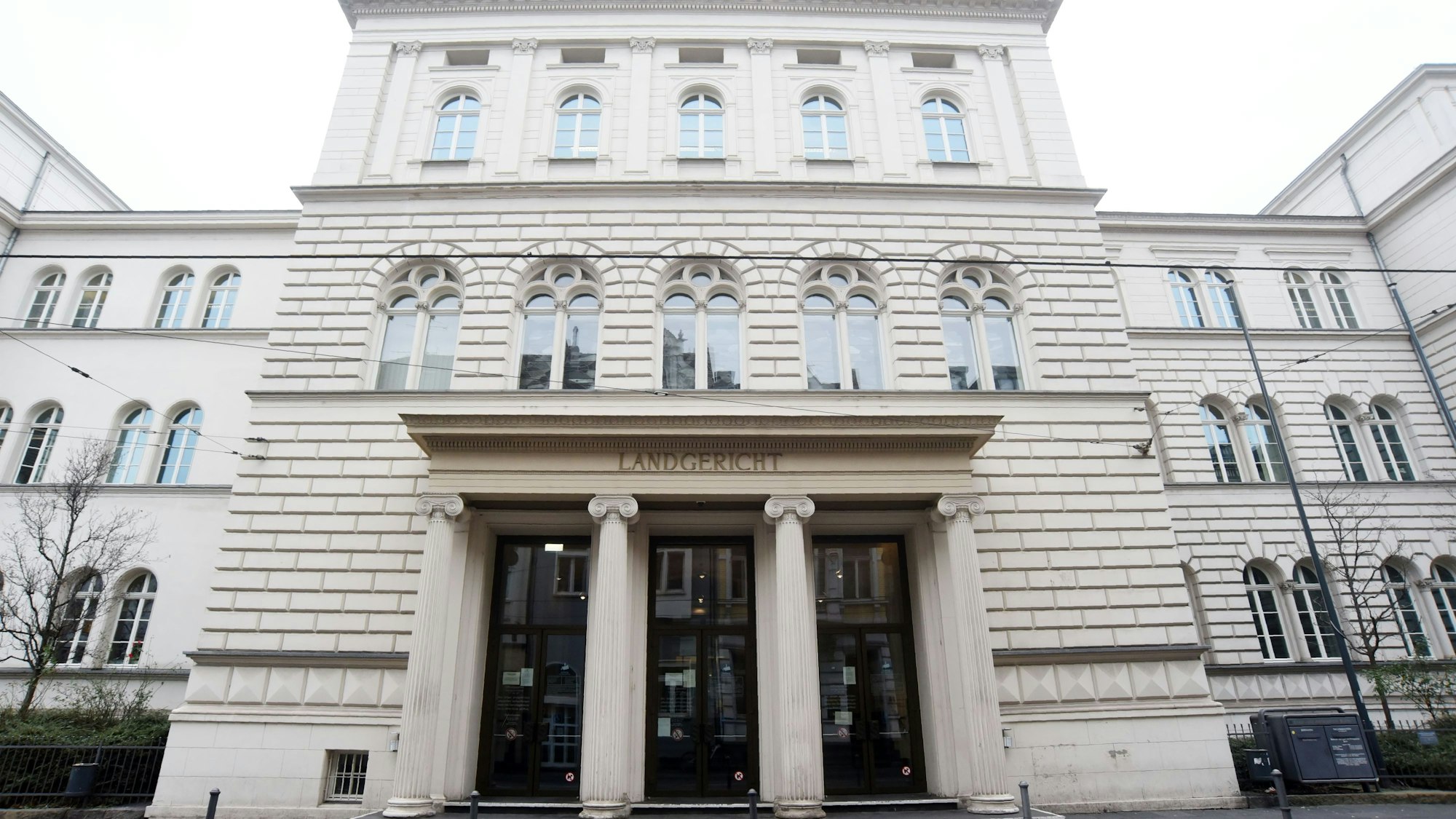 hohes weißes Gebäude mit großen Eingangstüren