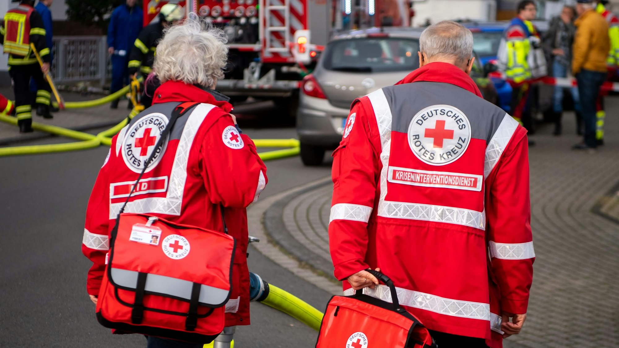 Zwei Mitarbeiter des Kriseninterventionsdienstes des DRK im Kreis Euskirchen gehen zu einem Einsatzort.