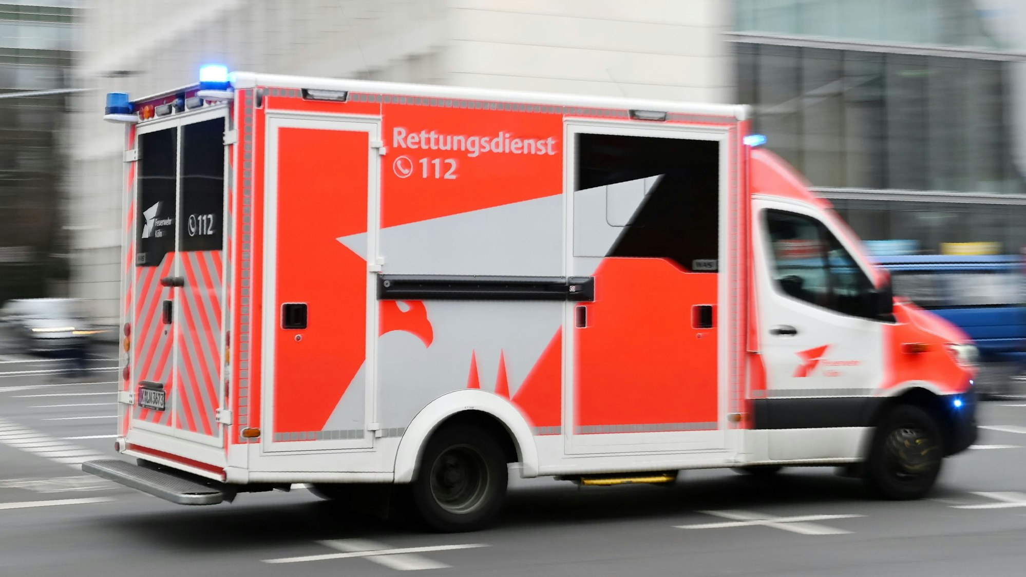 Zu sehen ist ein Einsatzfahrzeug des Kölner Rettungsdienstes im Einsatz in der Seitenansicht.