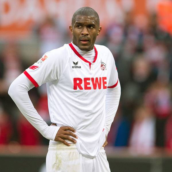 Fußballspieler Anthony Modeste steht im FC-Trikot auf dem Rasen und stützt die Hande in die Hüfte.