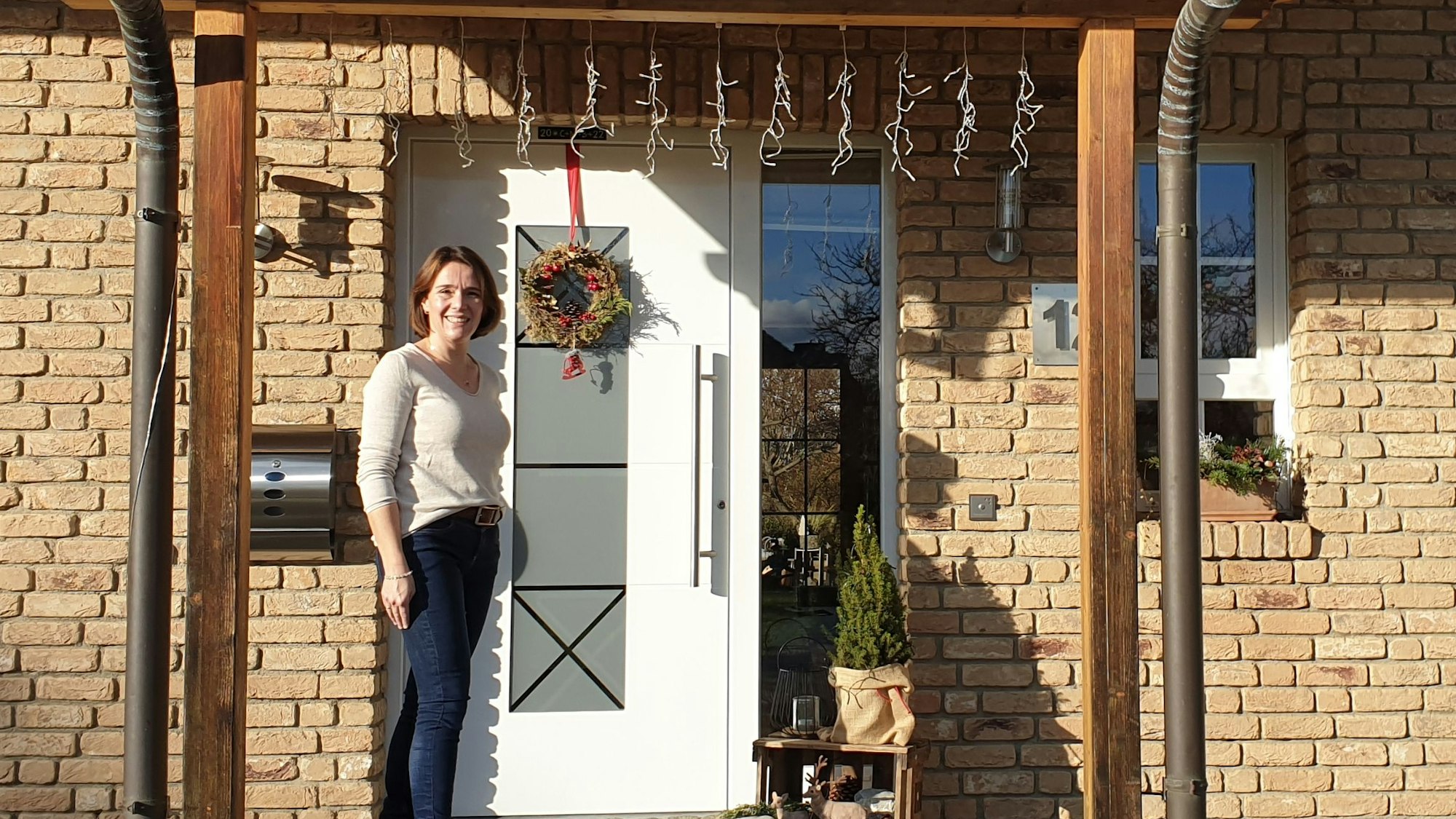 Hebamme Simone Bungenberg-Decker vor ihrem Haus und ihrer Praxis