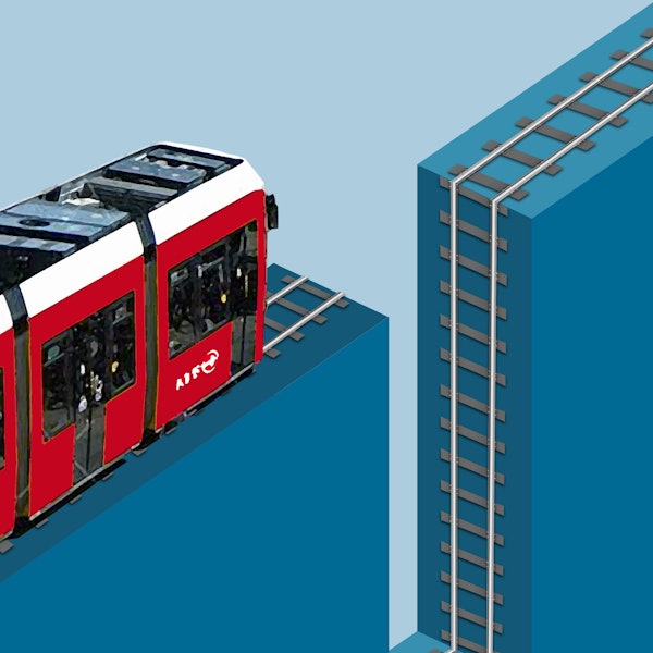 Eine rote KVB-Bahn fährt auf einer Schiene, die in den Abgrund führt.