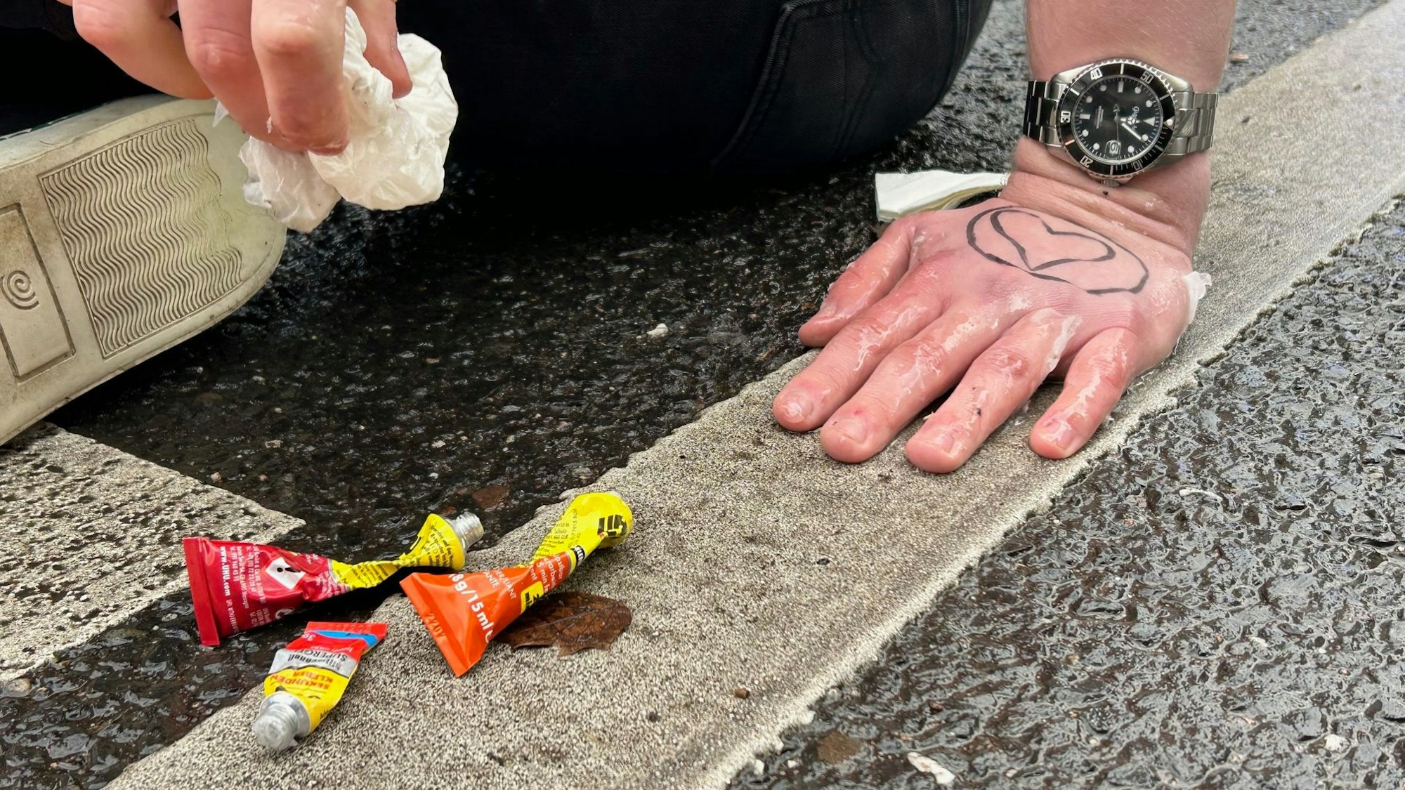 Aktivistinnen und Aktivisten der „Letzten Generation“ haben sich mit einem Spezialkleber auf der Cäcilienstraße in der Kölner Innenstadt festgeklebt.