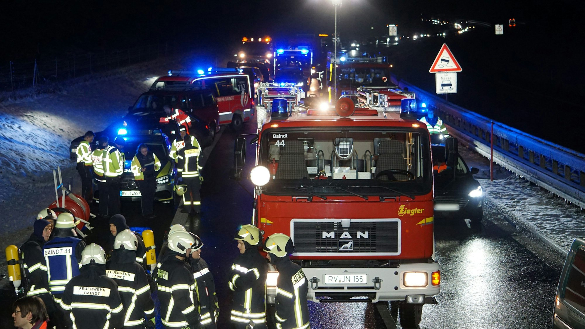 Helfer und Polizisten stehen nach einem schweren Verkehrsunfall.