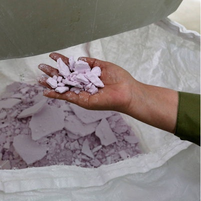 Eine Hand hält das Seltenerdmetall Neodym in der Hand