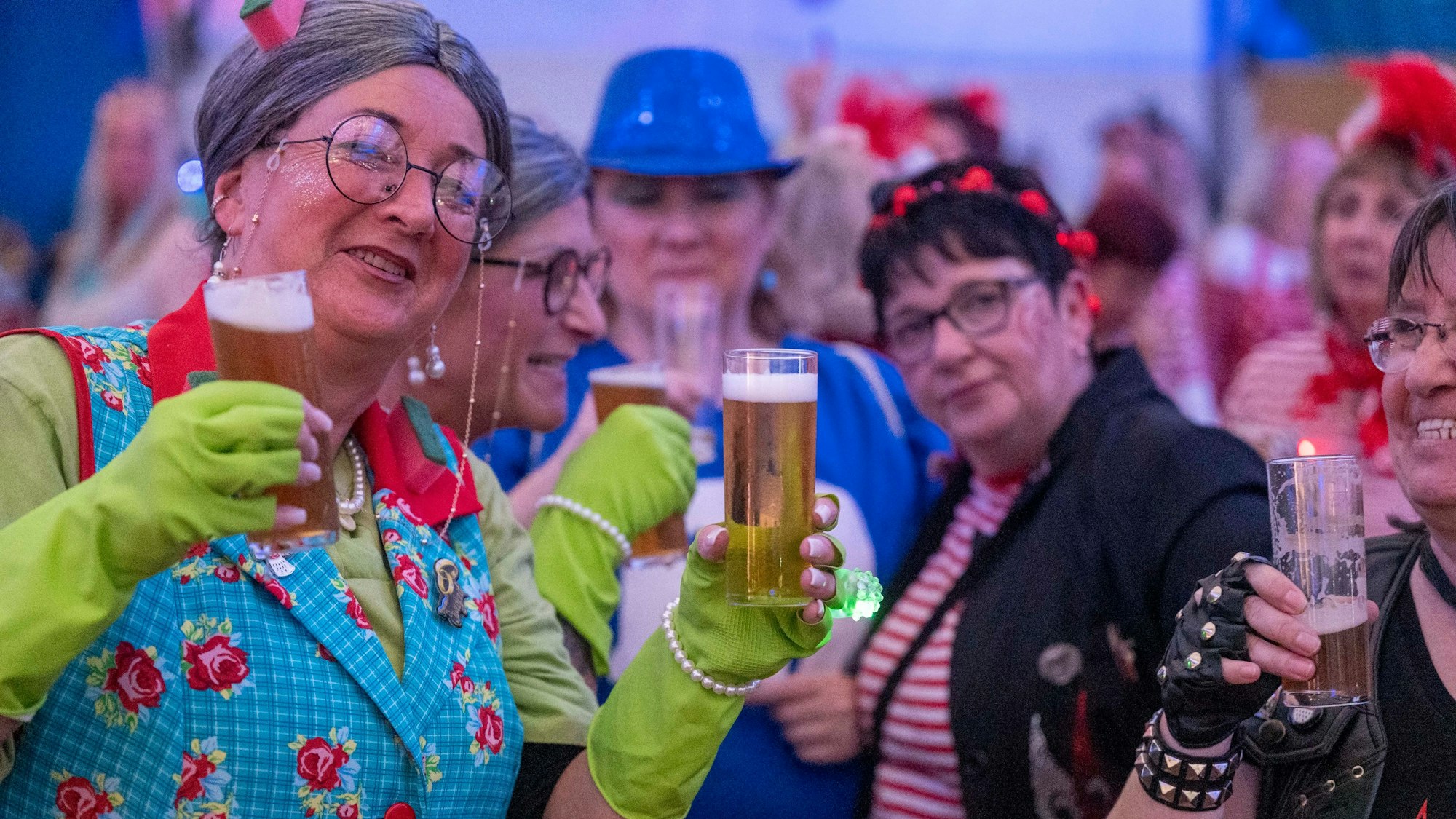 Vier verkleidete Frauen halten Kölsch in den Händen.