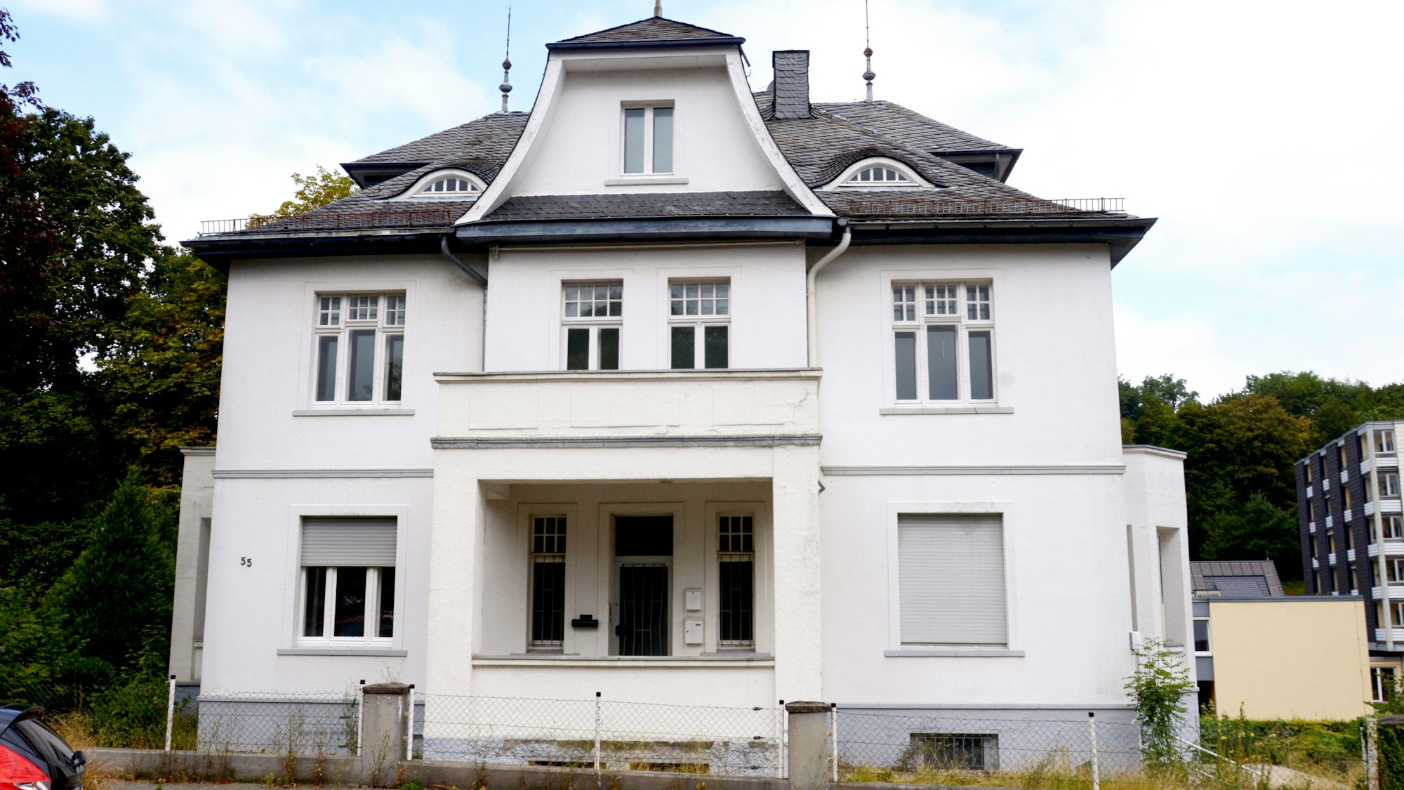 Eine weiße Villa mit dem brauen Dach